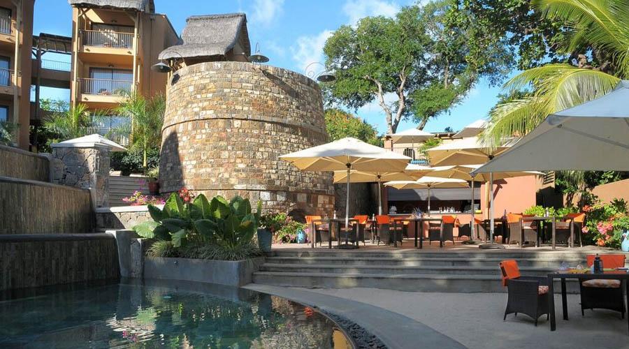 view of hotel and dining area from pool